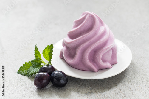 Black Grape gelato in the form of French Chantilly cream. On a plate. Light grey background