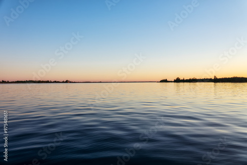 Potamology. The navigable Svir River in northwestern Russia at its confluence with Lake Ladoga. Part of White Sea - Baltic Canal. Springtime. The ice is gone, channel fairway, calm water surface