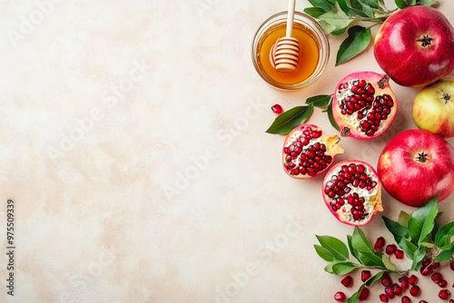 Rosh Hashanah holiday symbols on pastel background. Honey, apples, and pomegranate seeds, top view. Traditional food for Jewish New Year