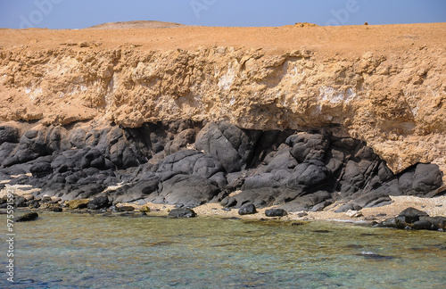 Black basaltic volcanic lava at the base of Big Brother Island in the Red Sea, Egypt