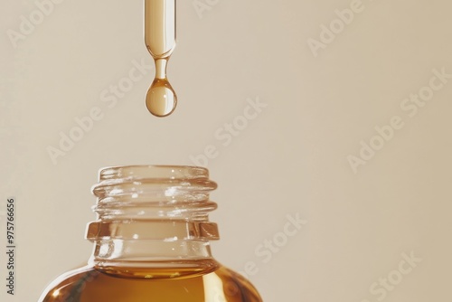 pipette tip releasing a drop of golden liquid into a bottle of serum, beauty and health product , wellness, youthful 