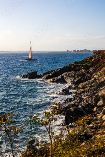 Trimaran on the Mediterranean Sea, seen from the lighthouse of Roses on the Costa Brava, Spain