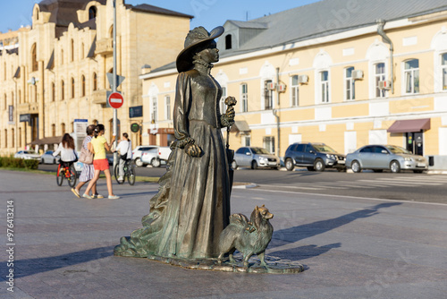 Russia. Astrakhan. Sculptural composition of a lady with a dog on Petrovskaya embankment.