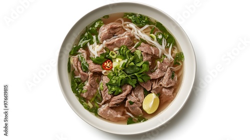 Delicious vietnamese pho with beef, fresh herbs, and lime in a white bowl on white background