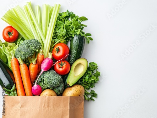 Fresh Produce Overflowing from a Brown Paper Bag on a White Background TopDown View