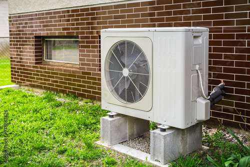 New air source heat pump installed outside of family house