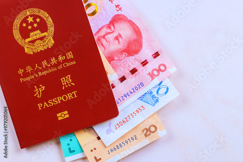 Chinese passport with Chinese cash currency in form of yuan cash banknotes of different denomination