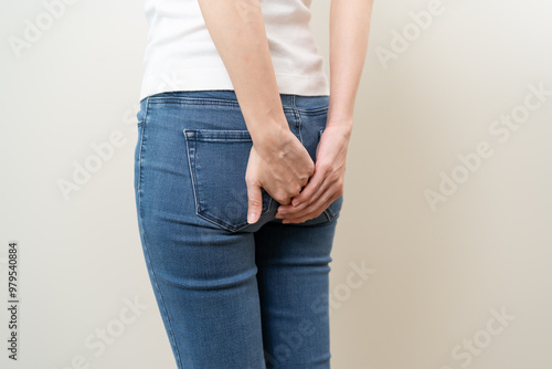 Health care, pain asian young woman suffering from hemorrhoid, anus, diarrhea and constipation, girl hand touching, holds butt, anal have abdominal, intestine problem, abscess disease and smell fart.