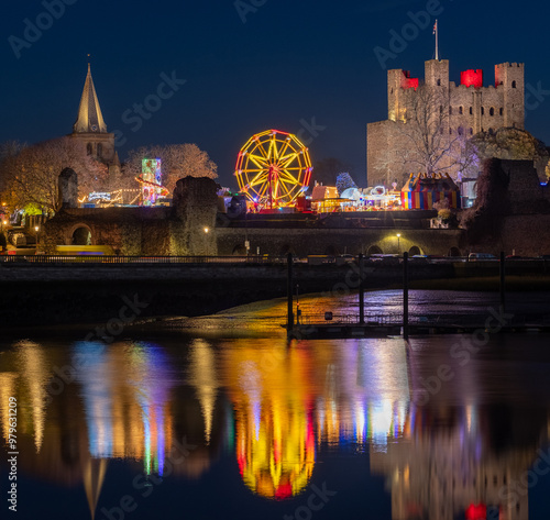 River Medway reflects Rochester Christmas Market in the Dark surrounded by Castle and Cathedral