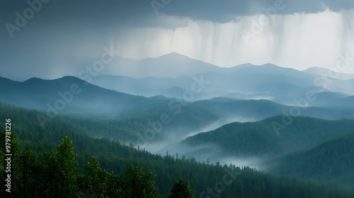 distant view of a rainstorm moving across the mountains, with mist rising from the forested