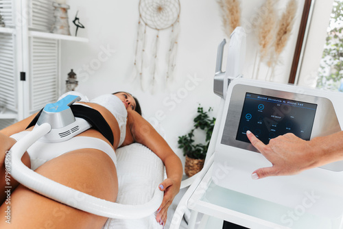 Body contouring and sculpting. Hardware cosmetology. Ultrasound cavitation body contouring treatment, anti-cellulite and anti-fat therapy in beauty salon. Modern beauty treatments concept.