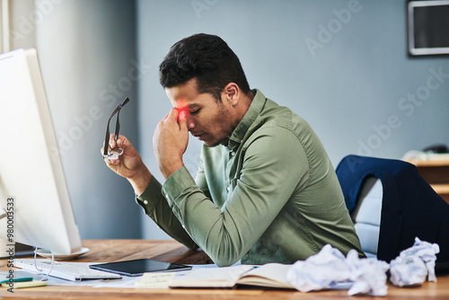 Man, stress and headache in office by computer with glass, pain or red glow with chaos at company. Business person, tired and fatigue with migraine, exhausted and burnout with mess by pc at workplace