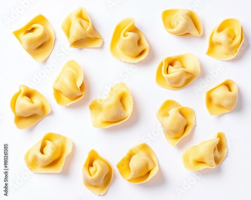 An overhead view of fresh, uncooked tortellini pasta shells arranged on a white background, perfect for culinary presentations.