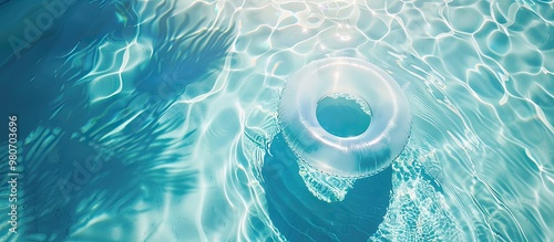 Aerial shot of a rubber ring floating in a transparent pool providing ample room for text in an inviting summer resort advertisement featuring a serene copy space image