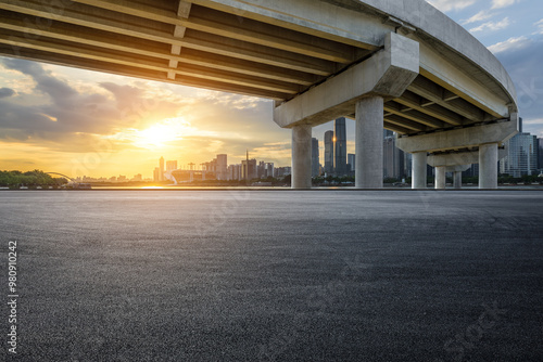 Asphalt road square and bridge with modern city buildings scenery at sunset in Guangzhou. car advertising background.