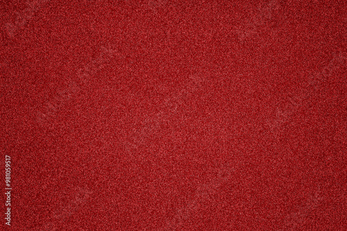 The vibrant red surface features fine grains and a smooth texture, highlighting the richness of color perfect for creative projects or background settings