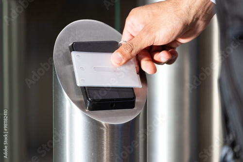 Scanning access card, person entering secure office building for work