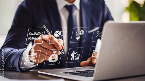 A focused executive engages with a virtual financial planning interface on his laptop, symbolizing sophisticated financial management in a digital era.