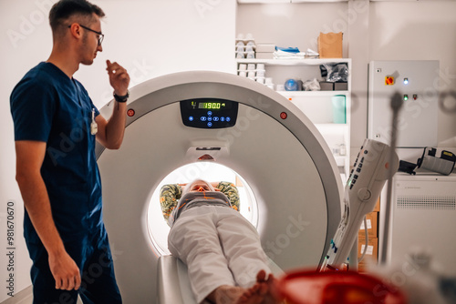 High-tech CT scan machine operating with patient in hospital room.