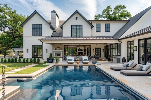 A luxury modern farmhouse style home with large outdoor pool and patio area, perfectly symmetrical, highend camera shot