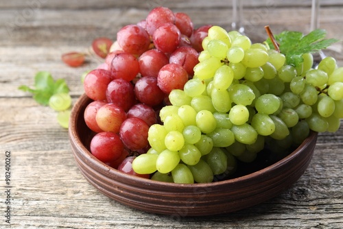 Delicious fresh ripe grapes on wooden table