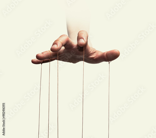 Puppeteer's hands with strings on each finger on white background.