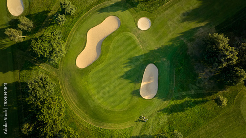 Aerial View of Golf Course Green and Bunkers, howcasing a well-maintained green surrounded by sandy bunkers.