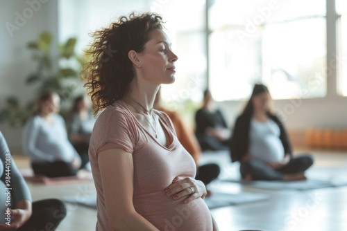 Pregnant woman of Caucasian descent participating in a prenatal yoga class with others in a serene studio.