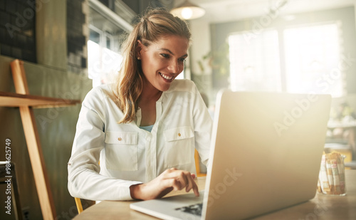 Woman, laptop and coffee shop for online news, freelancer and website for article research. Female person, restaurant and reporter to review bistro service or hospitality, typing column and media