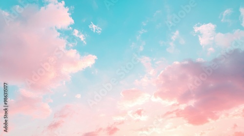 Delicate blue and pink pastel sky with light clouds as the sun sets