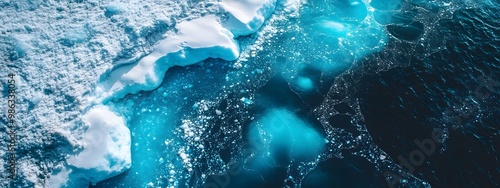 An aerial view of an iceberg floating in the water, showcasing its massive size and intricate details. The cold blue tones of the ice contrast with the dark ocean waters.