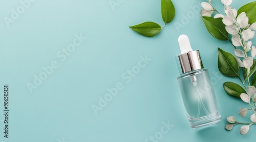 Bright turquoise bottle with pump dispenser and soft towels on minimalist background