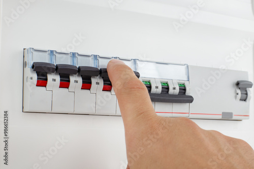 Hand Switching Off Electrical Circuit Breaker