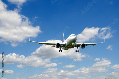 White passenger airplane flying in the sky amazing clouds in the background - Travel by air transport. High quality photo