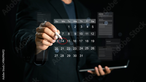 Time management concept. Businessman manages time for effective work. Calendar on the virtual screen interface. Highlight appointment reminders and meeting agenda on the calendar.