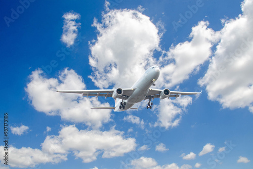 White passenger airplane flying in the sky amazing clouds in the background - Travel by air transport. High quality photo