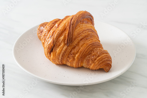 fresh croissant on white plate