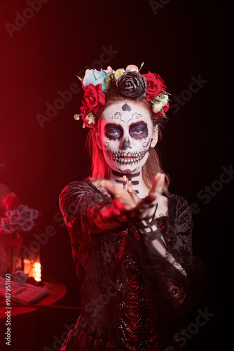 Woman doing enticing invitation hand gesture at Day of the Dead event to remember the deceased. Lady doing seducing wooing gesturing during Mexican holiday of remembrance for those who have passed