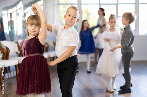 Children dance in pairs at a festive matinee