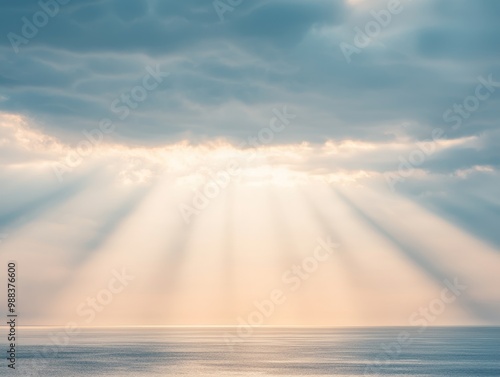 Sunbeams burst through clouds over a calm ocean. The sky is a gradient of blue and pink, with a soft glow. The water is smooth and serene.