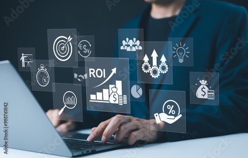 Analyzing ROI and Business Strategy Concepts. Businessman working on a laptop with various digital icons representing ROI, financial strategies, return on investment, and efficiency. marketing plan,