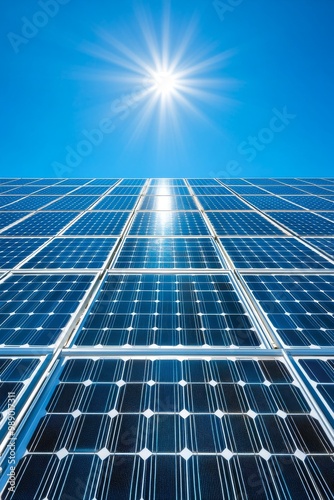 Solar panels reflecting sunlight in a clear blue sky, showcasing renewable energy and sustainability.