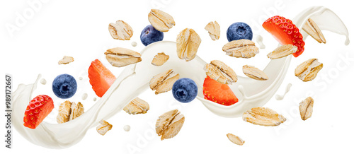 Falling oat flakes with blueberry and strawberry slices, oatmeal with milk splash isolated on white background, package design concept