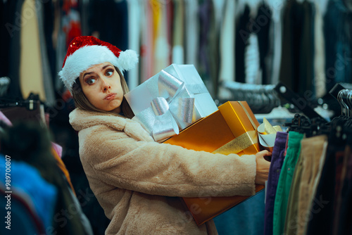 Tired Christmas Woman Shopping Extensively in the Last Minute. Stressed girl carrying heavy presents regretting impulse buy 