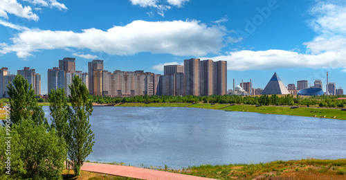 High-rise residential buildings on the banks of the Ishim River in the capital of Kazakhstan, Astana, on a summer day