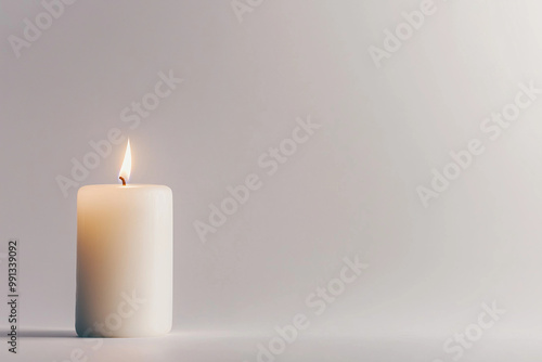 A single lit candle glows softly on a white background, casting gentle shadows, symbolizing remembrance, hope, and prayers for the faithful departed on All Souls' Day.