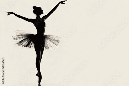 Silhouette of a young ballerina dancing gracefully in tutu dress