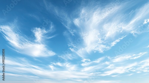 A tranquil scene with cirrus clouds, wispy and thin, high in the sky on a clear day, symbolizing fair weather.