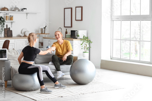 Sporty young women training at home