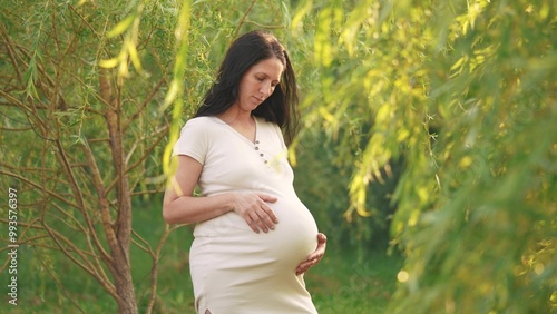 pregnant woman. a young mother is impatiently waiting for her child, hugging her lifestyle belly. motherhood, pregnancy, happy family, kid dream concept. a woman experiences maternal happiness